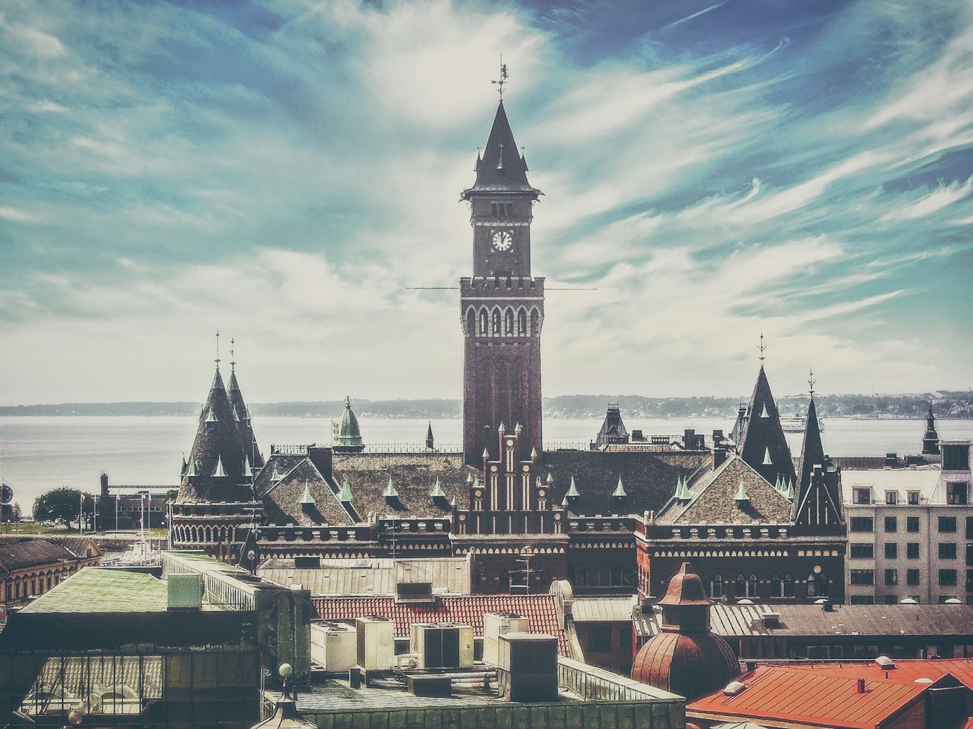 Rooftops and a tall clock tower above the Oresund