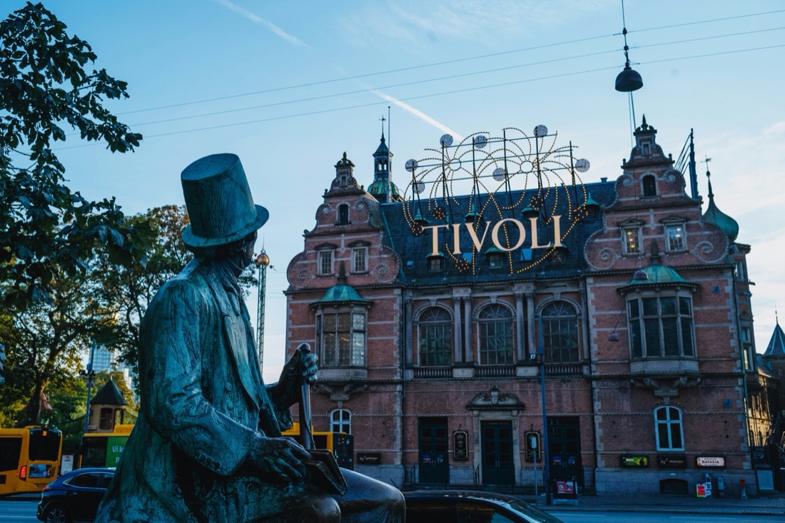 The Hans Christian Andersen statue in front of the Tivoli sign